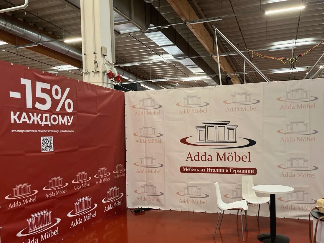 Messestand mit bedruckten Wänden und Bannern eines Möbelhändlers